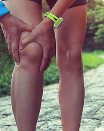 a person holding his injured knee