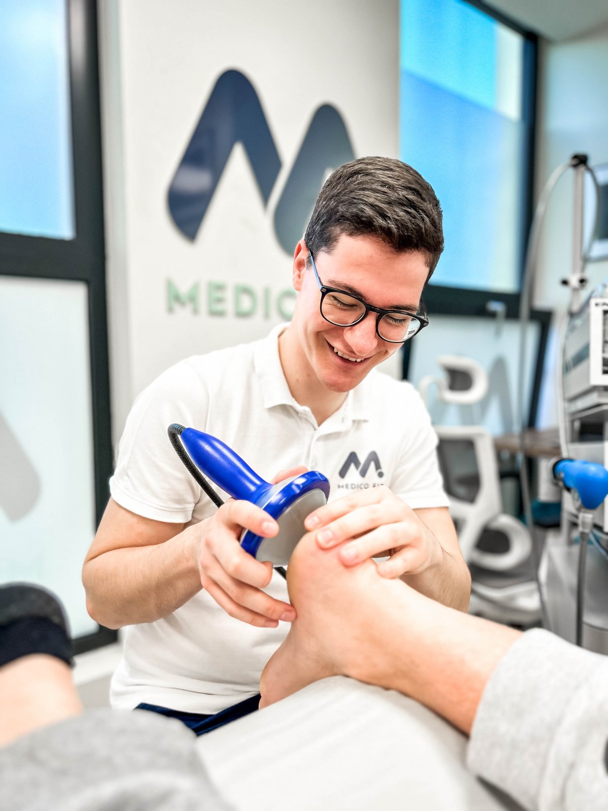 fizioterapevt uporablja sodobno tehnologijo za zdravljenje pete