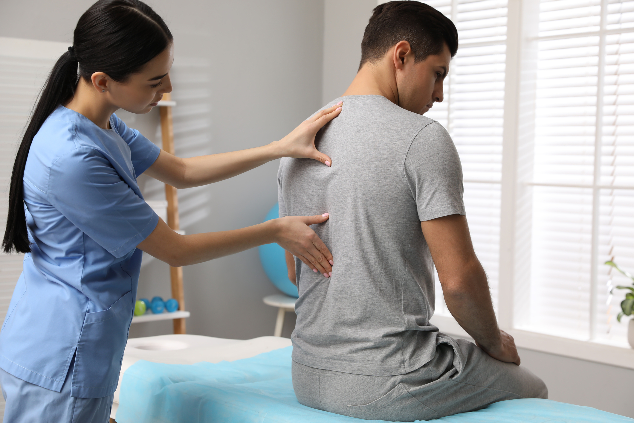 Orthopedist Examining Man S Back In Clinic Scoliosis Treatment 240662059